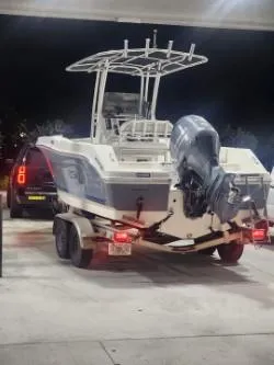 Slide: The Image of 2018 Robalo R200 Center Console boat on trailer at night. - 0