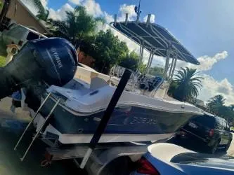Slide: The Image of 2018 Robalo R200 Center Console boat on trailer, parked outdoors. - 1
