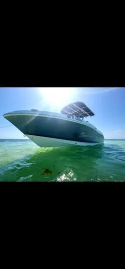 Slide: The Image of 2018 Robalo R200 Center Console boat on clear water under bright sun. - 2