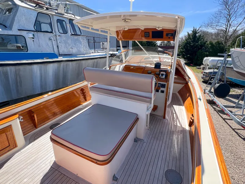 Slide: The Image of 2003 Padebco V27 Center Console boat with spacious seating and elegant wood accents. - 11