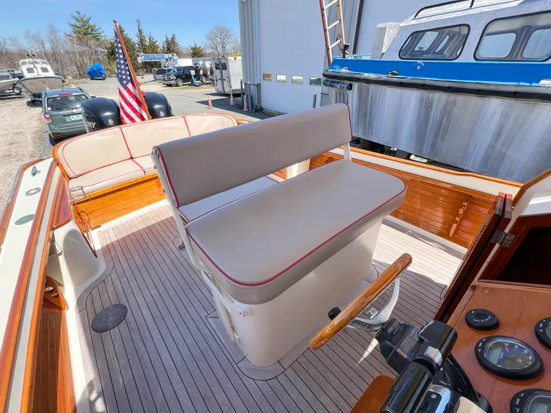 Slide: The Image of 2003 Padebco V27 Center Console boat interior with seating and American flag. - 28