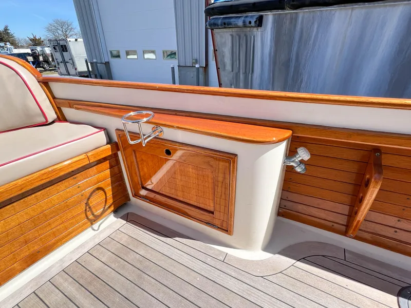 Slide: The Image of 2003 Padebco V27 Center Console boat with wooden interior and seating. - 32