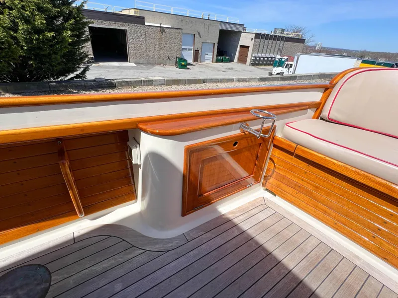 Slide: The Image of 2003 Padebco V27 Center Console boat interior with wooden accents and seating. - 33