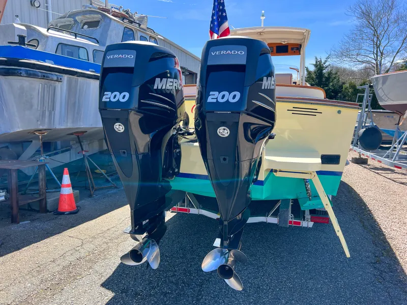 Slide: The Image of 2003 Padebco V27 Center Console with twin Mercury Verado 200 engines, docked outdoors. - 38