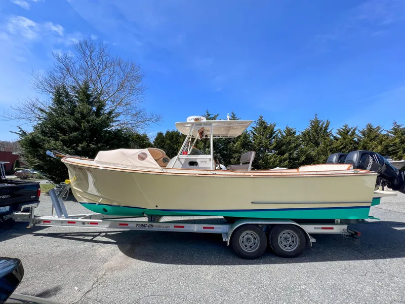 Slide: The Image of 2003 Padebco V27 Center Console boat on trailer, parked outdoors. - 4