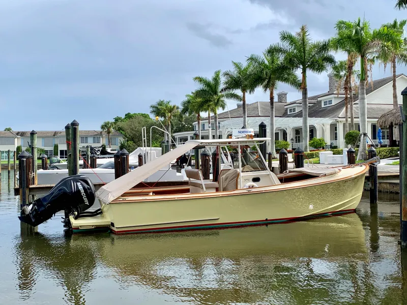 Slide: The Image of 2003 Padebco V27 Center Console boat docked near palm trees and waterfront homes. - 6