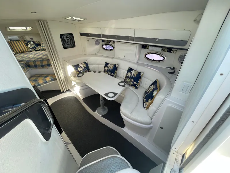 Slide: The Image of Interior of 1998 Donzi 3250 LXC boat with white seating and nautical decor. - 13