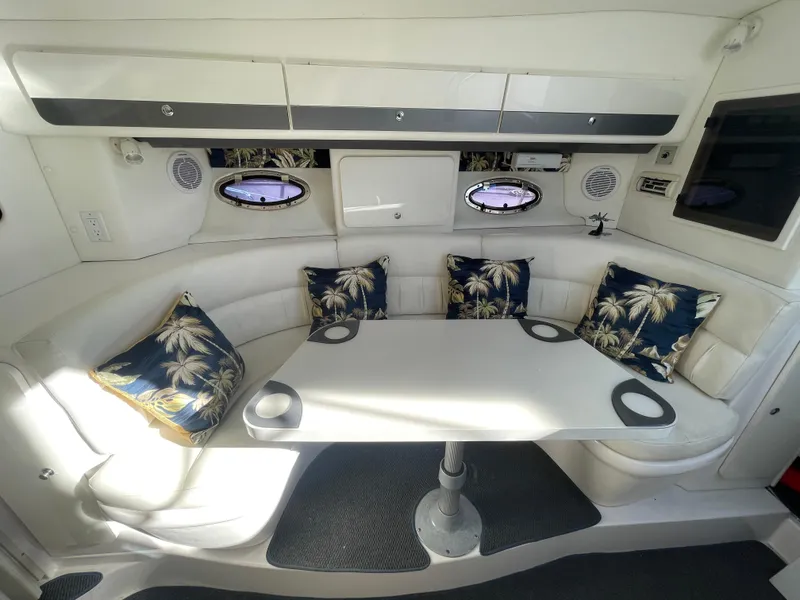 Slide: The Image of Interior of 1998 Donzi 3250 LXC boat with white seating and tropical cushions. - 15