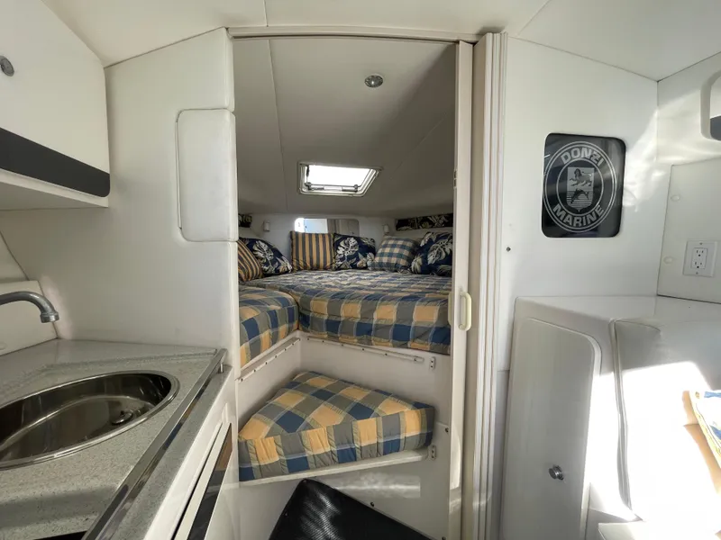 Slide: The Image of Interior of 1998 Donzi 3250 LXC boat with cozy cabin and kitchenette. - 17