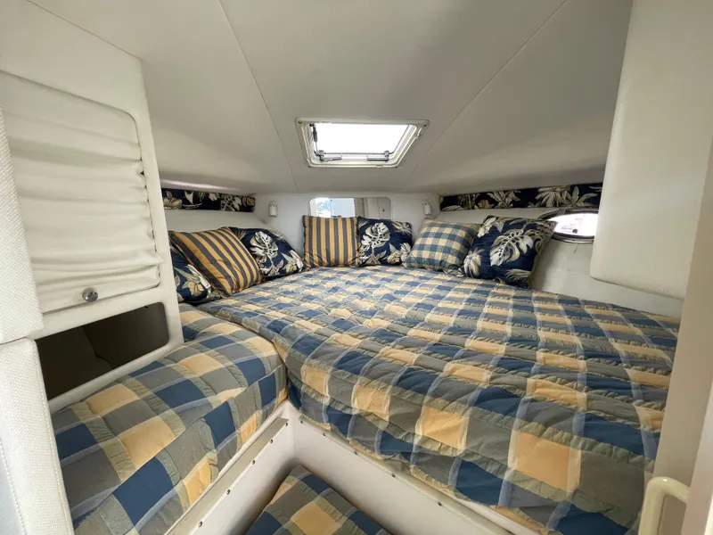 Slide: The Image of Cozy cabin interior of 1998 Donzi 3250 LXC with plaid bedding and floral pillows. - 18