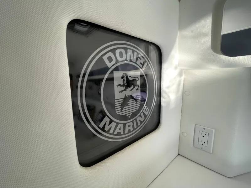 Slide: The Image of 1998 Donzi 3250 LXC interior with Donzi Marine logo on window. - 19