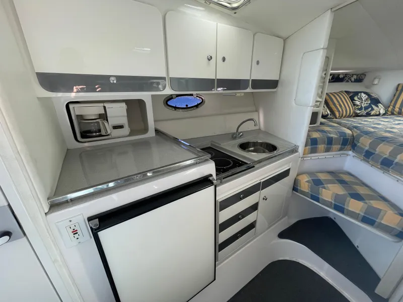 Slide: The Image of 1998 Donzi 3250 LXC boat interior with kitchenette and sleeping area. - 22