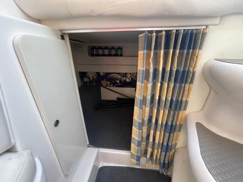 Slide: The Image of Interior cabin of 1998 Donzi 3250 LXC boat with curtain and seating area. - 25