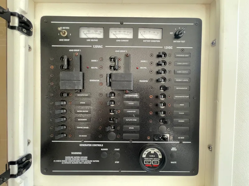 Slide: The Image of Control panel of a 1998 Donzi 3250 LXC boat, featuring various switches and meters. - 26