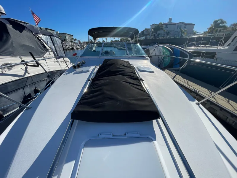Slide: The Image of 1998 Donzi 3250 LXC boat docked in sunny marina, front deck view. - 30