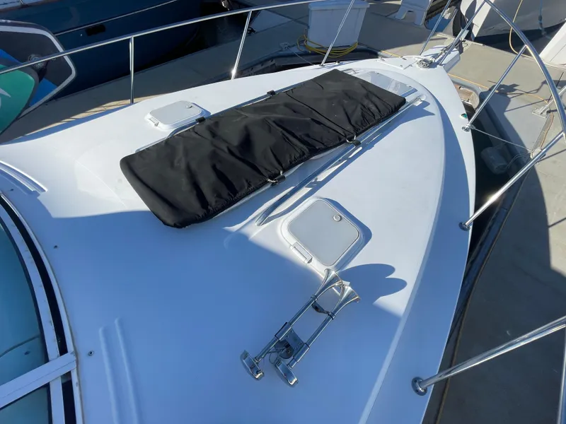 Slide: The Image of 1998 Donzi 3250 LXC boat deck with black cover and railing. - 31