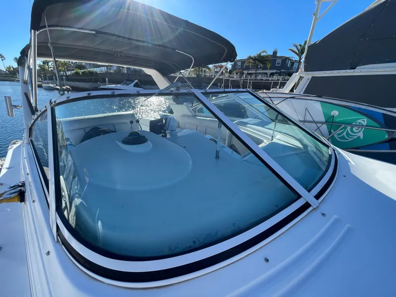 Slide: The Image of 1998 Donzi 3250 LXC boat with canopy, docked in sunny marina. - 32