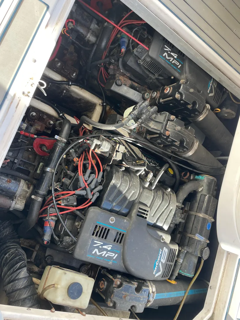 Slide: The Image of Engine compartment of a 1998 Donzi 3250 LXC boat, featuring twin 7.4 MPI engines. - 34