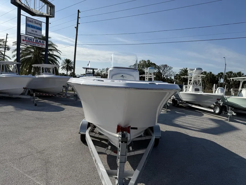 Slide: The Image of 2024 Aquasport 2100 CC boat on trailer at dealership, sunny day. - 3