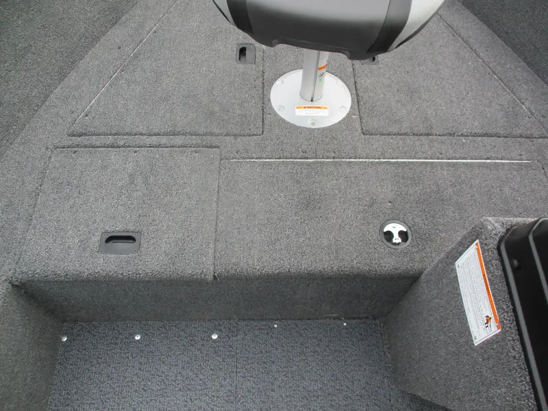 Slide: The Image of 2025 Lund Rebel XL 1650 SS boat interior with gray carpet and seating. - 11
