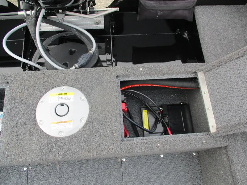 Slide: The Image of 2025 Lund Rebel XL 1650 SS boat interior showing battery compartment and wiring. - 16