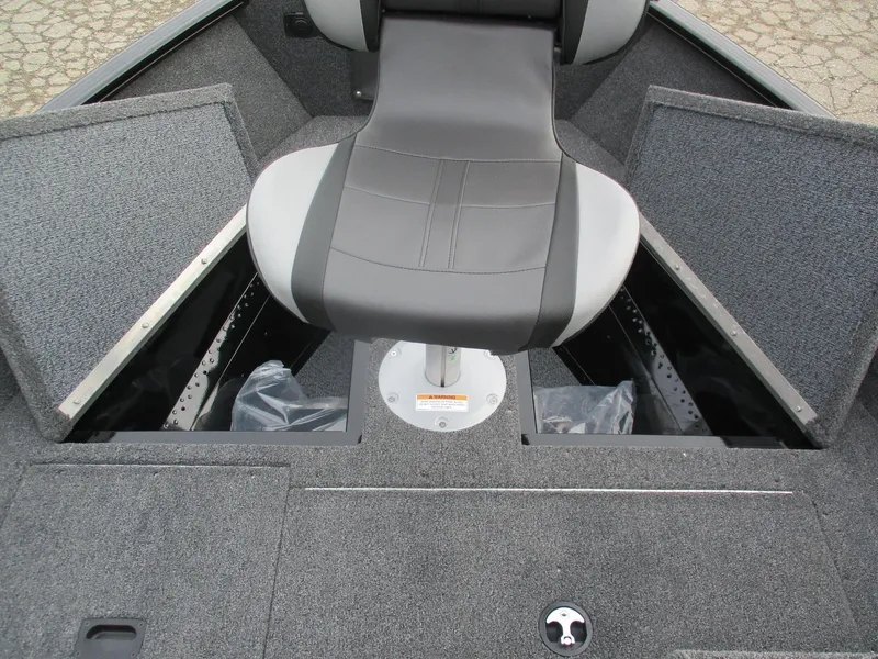 Slide: The Image of 2025 Lund Rebel XL 1650 SS boat interior with storage compartments and seating. - 5
