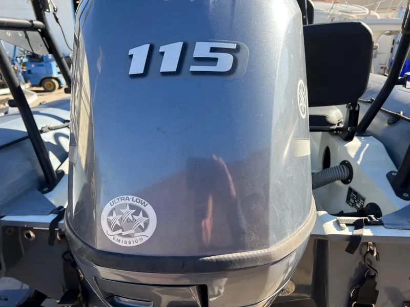 Slide: The Image of 2020 Zodiac Pro 5.5 boat with T-top in a garage setting. - 11