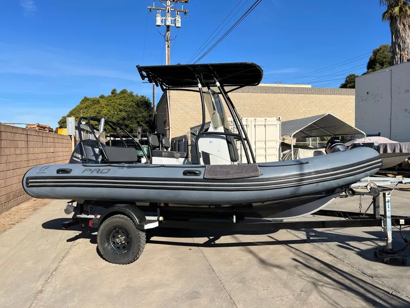 Slide: The Image of 2020 Zodiac Pro 5.5 inflatable boat on trailer in a garage setting. - 2