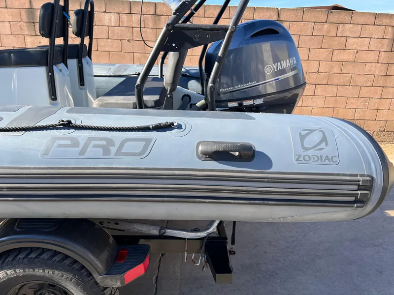 Slide: The Image of 2020 Zodiac Pro 5.5 with Yamaha 115 outboard motor in a sunny outdoor setting. - 21