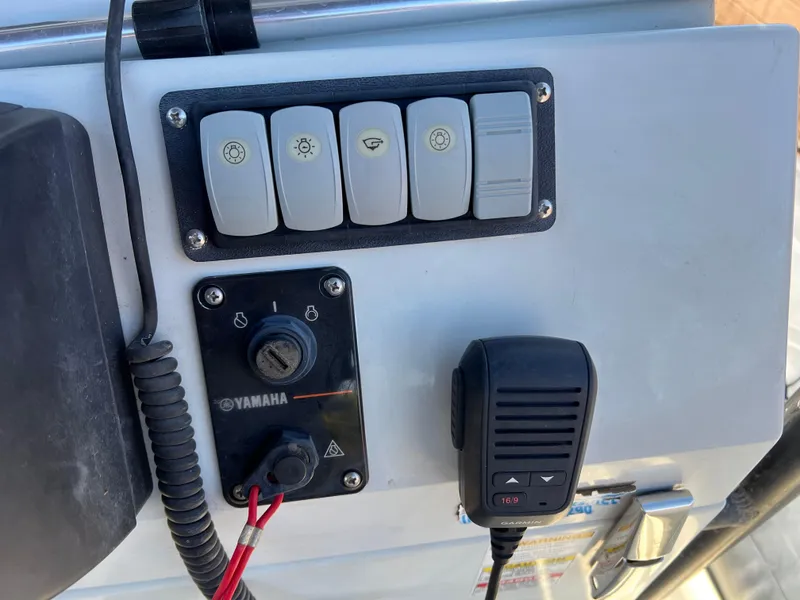 Slide: The Image of 2020 Zodiac Pro 5.5 boat with sturdy black canopy under clear blue sky. - 23