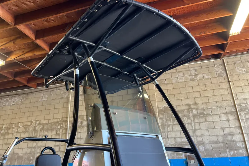 Slide: The Image of T-top of a 2020 Zodiac Pro 5.5 boat in a garage setting. - 27