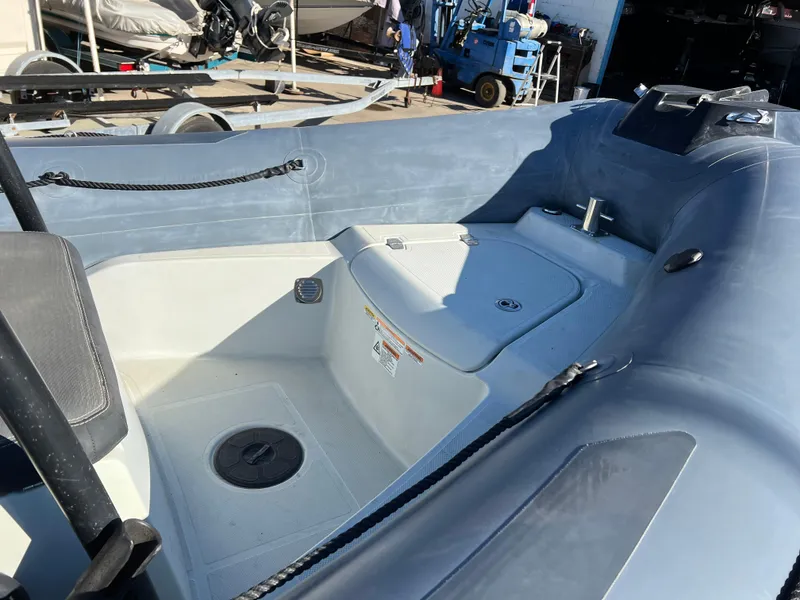 Slide: The Image of 2020 Zodiac Pro 5.5 inflatable boat interior with storage compartment and seating. - 6