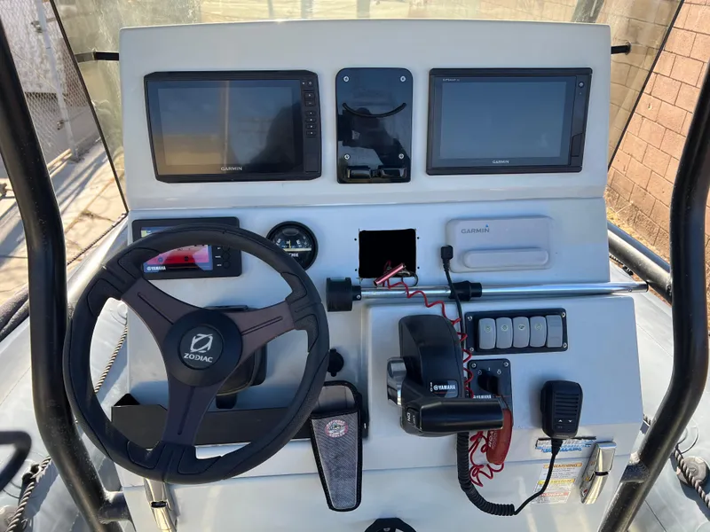 Slide: The Image of 2020 Zodiac Pro 5.5 inflatable boat with Yamaha engine in a garage setting. - 7