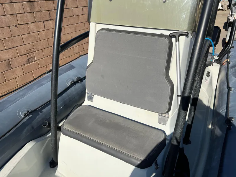 Slide: The Image of 2020 Zodiac Pro 5.5 boat interior with seating and Yamaha engine in a showroom. - 8