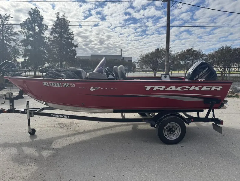 Slide: The Image of 2015 Tracker Pro Guide V-16 SC boat on trailer, parked outdoors. - 10