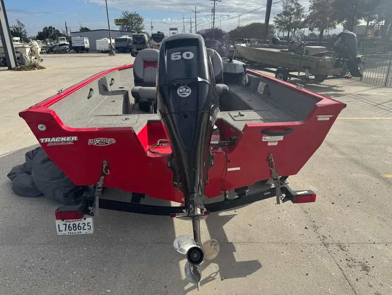 Slide: The Image of 2015 Tracker Pro Guide V-16 SC boat with 60 HP motor, red exterior. - 3