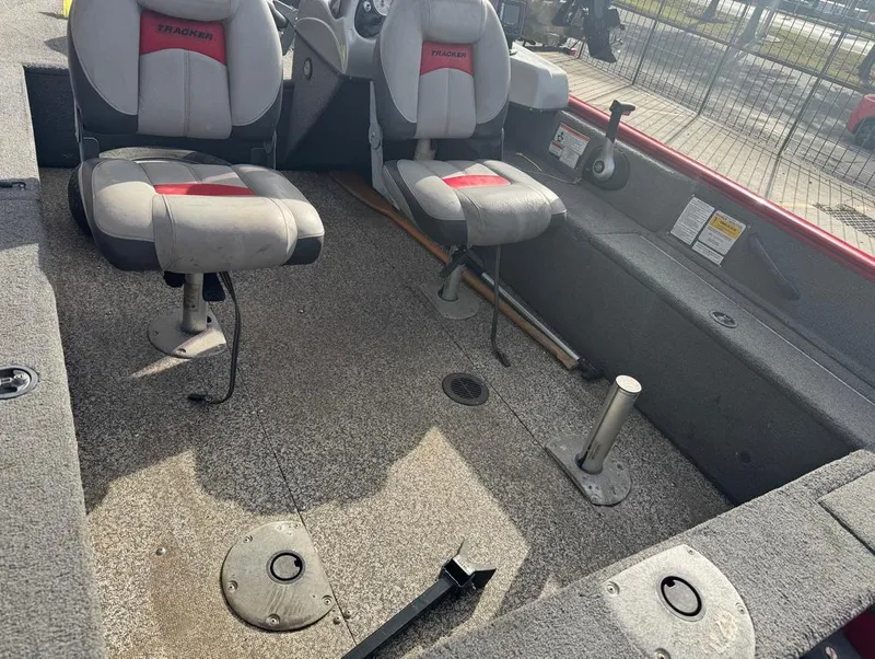 Slide: The Image of 2015 Tracker Pro Guide V-16 SC boat interior with two seats and fishing rod holders. - 5