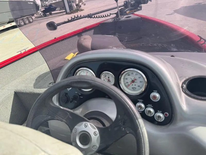 Slide: The Image of 2015 Tracker Pro Guide V-16 SC boat dashboard with steering wheel and gauges. - 6