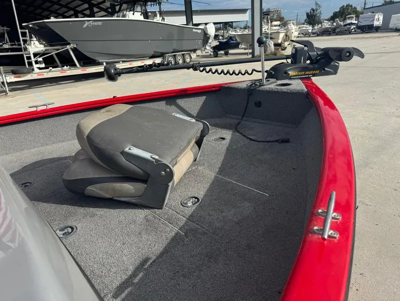 Slide: The Image of 2015 Tracker Pro Guide V-16 SC boat interior with red trim and folded seat. - 7