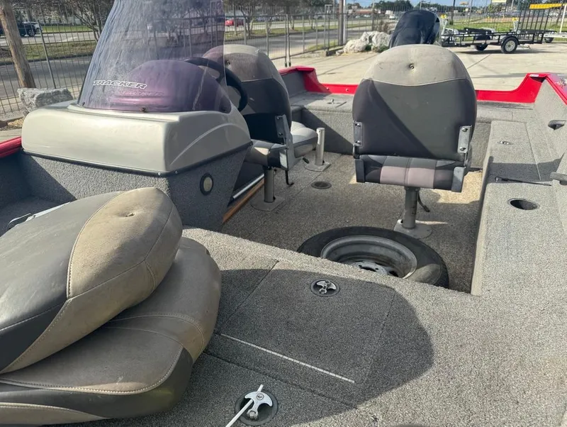 Slide: The Image of 2015 Tracker Pro Guide V-16 SC boat interior with seating and steering console. - 8