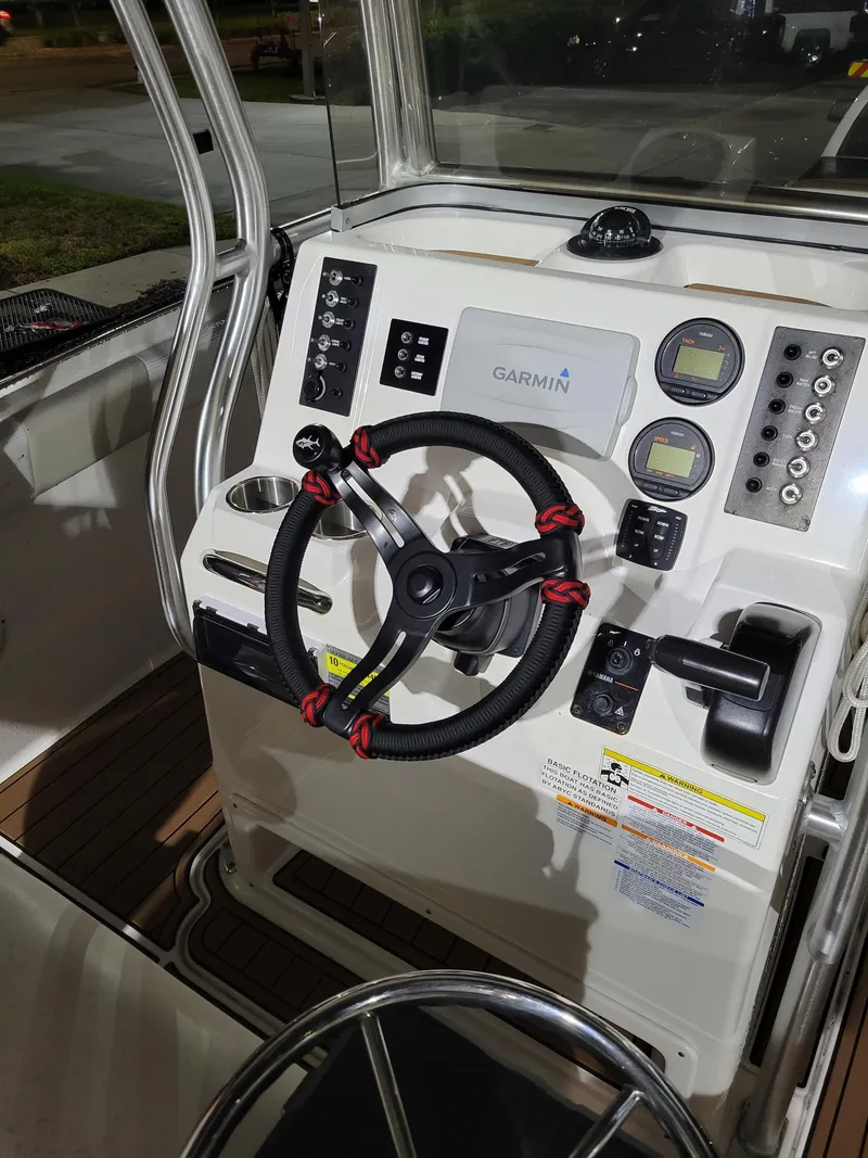 Slide: The Image of 2014 Robalo R222 Center Console boat dashboard with Garmin navigation system. - 10