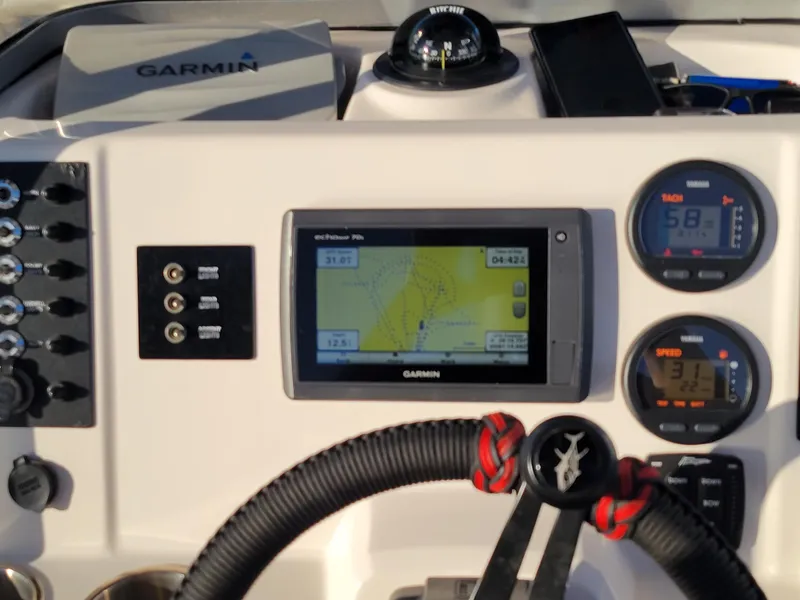 Slide: The Image of 2014 Robalo R222 Center Console dashboard with Garmin GPS and gauges. - 11