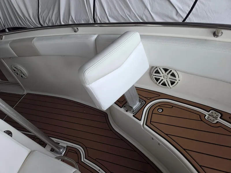 Slide: The Image of 2014 Robalo R222 Center Console boat interior with white seating and teak flooring. - 15