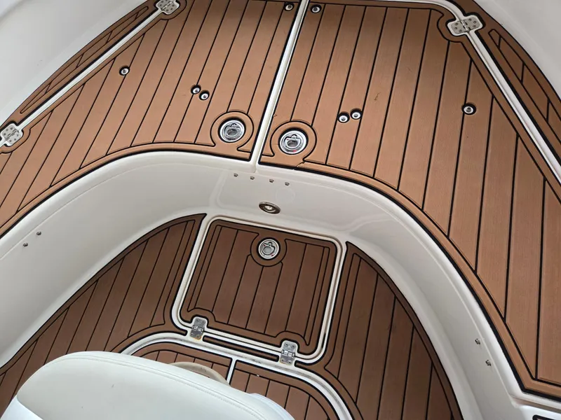 Slide: The Image of 2014 Robalo R222 Center Console boat deck with teak-style flooring. - 16
