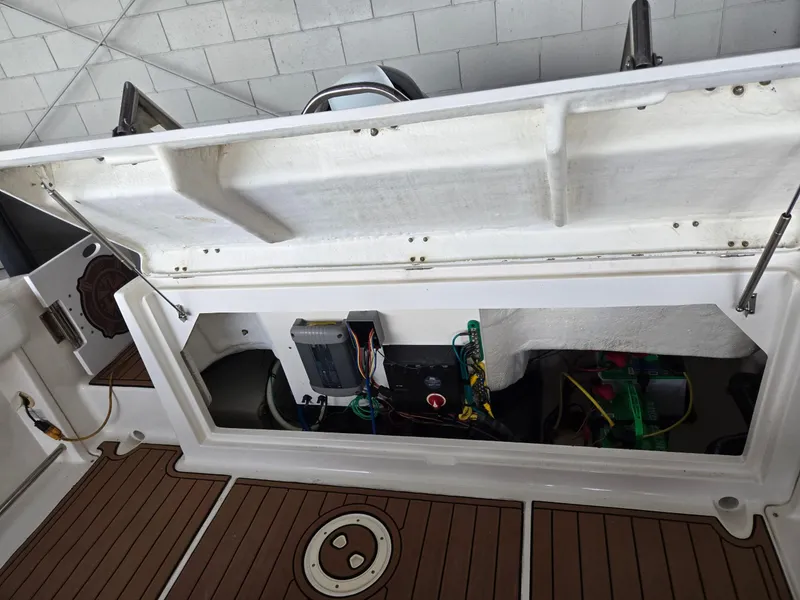 Slide: The Image of 2014 Robalo R222 Center Console boat storage compartment with wiring and equipment. - 18