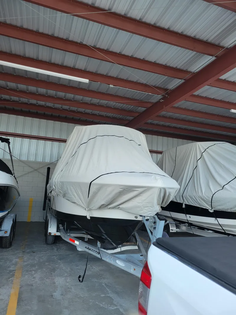 Slide: The Image of 2014 Robalo R222 Center Console boat covered in storage. - 2