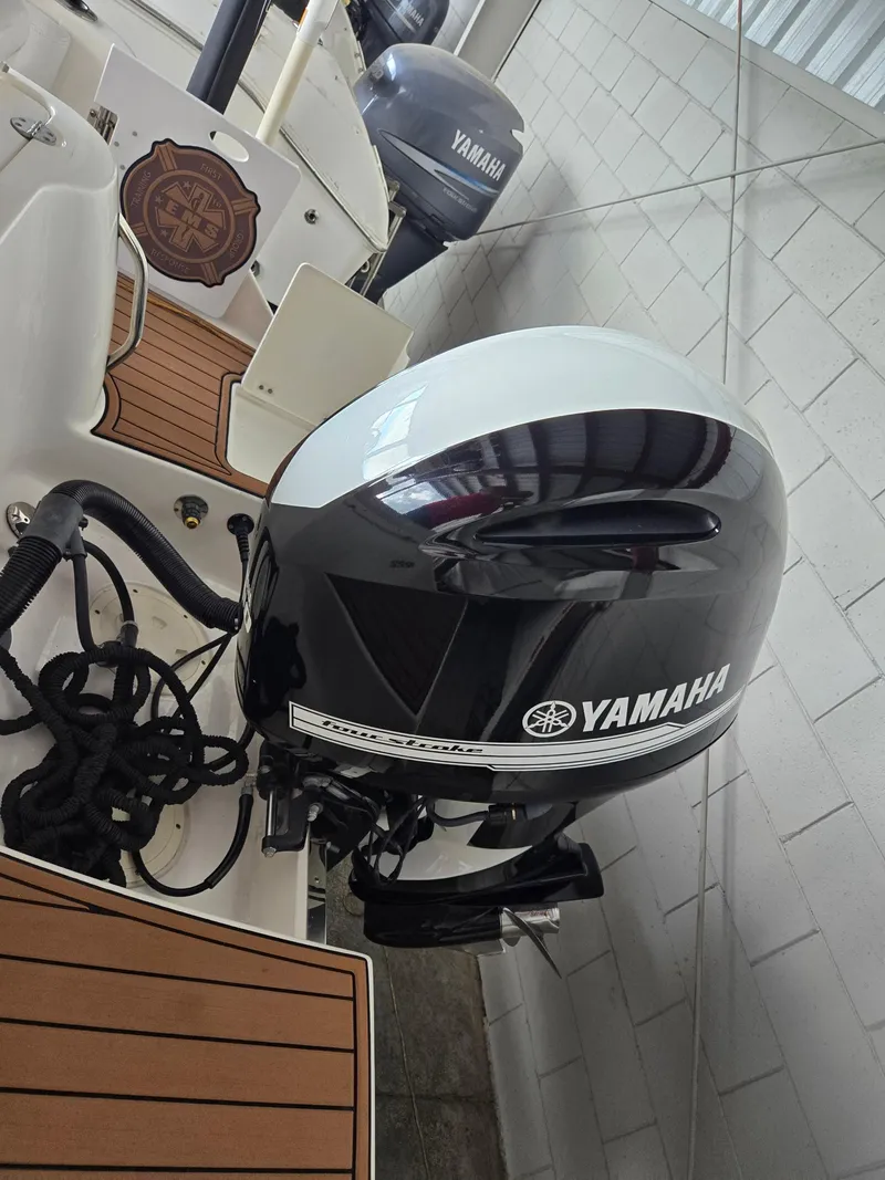 Slide: The Image of 2014 Robalo R222 Center Console with Yamaha outboard motor in a showroom. - 5