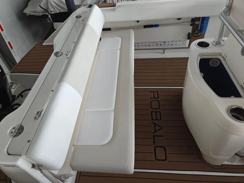 Slide: The Image of 2014 Robalo R222 Center Console boat interior with white seating and teak flooring. - 6