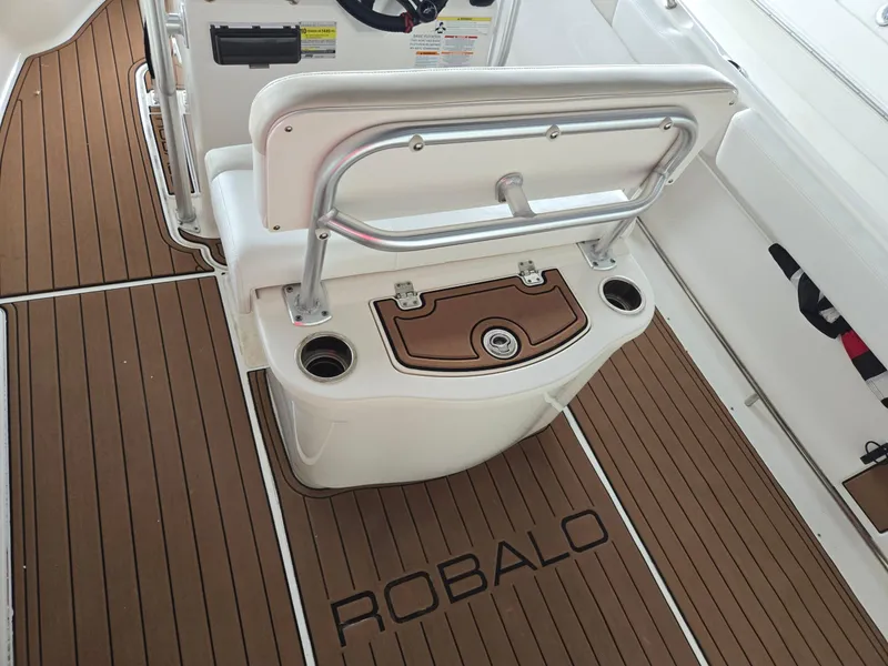 Slide: The Image of 2014 Robalo R222 Center Console boat interior with teak flooring and seating. - 8