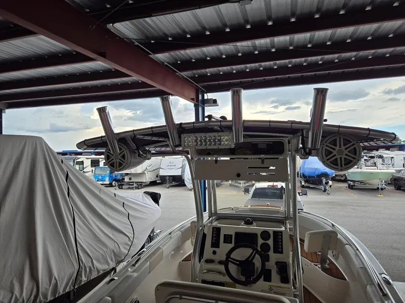 Slide: The Image of 2014 Robalo R222 Center Console boat under a metal canopy in a storage area. - 9
